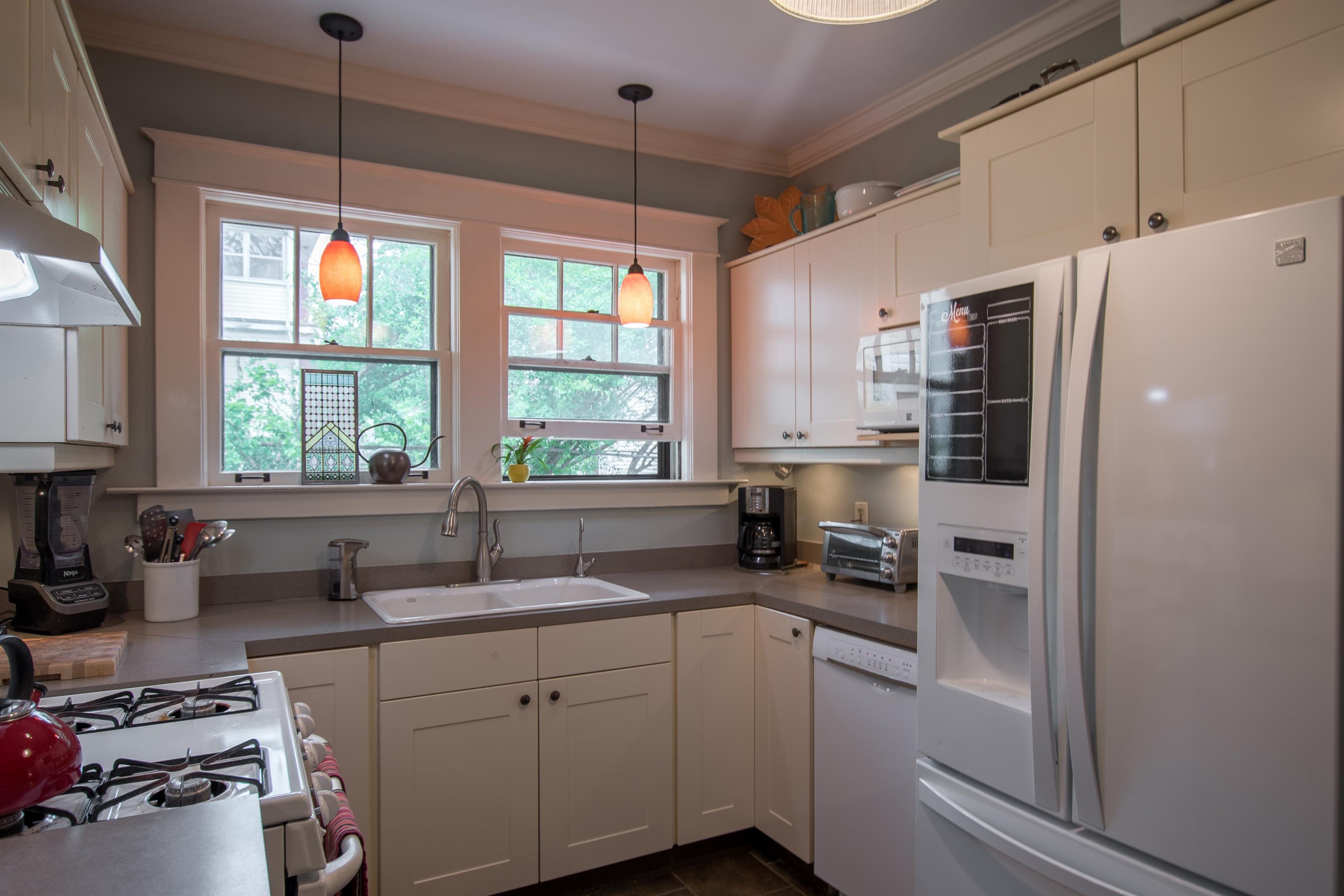 793 Rozelle Street Memphis, TN 38104 - Photo 7 of 23 kitchen with double window, gas cooking and shaker cabinets