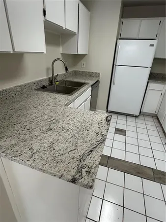 a kitchen with a sink a stove and a counter top space