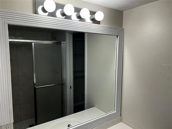 a bathroom with a sink vanity and a mirror