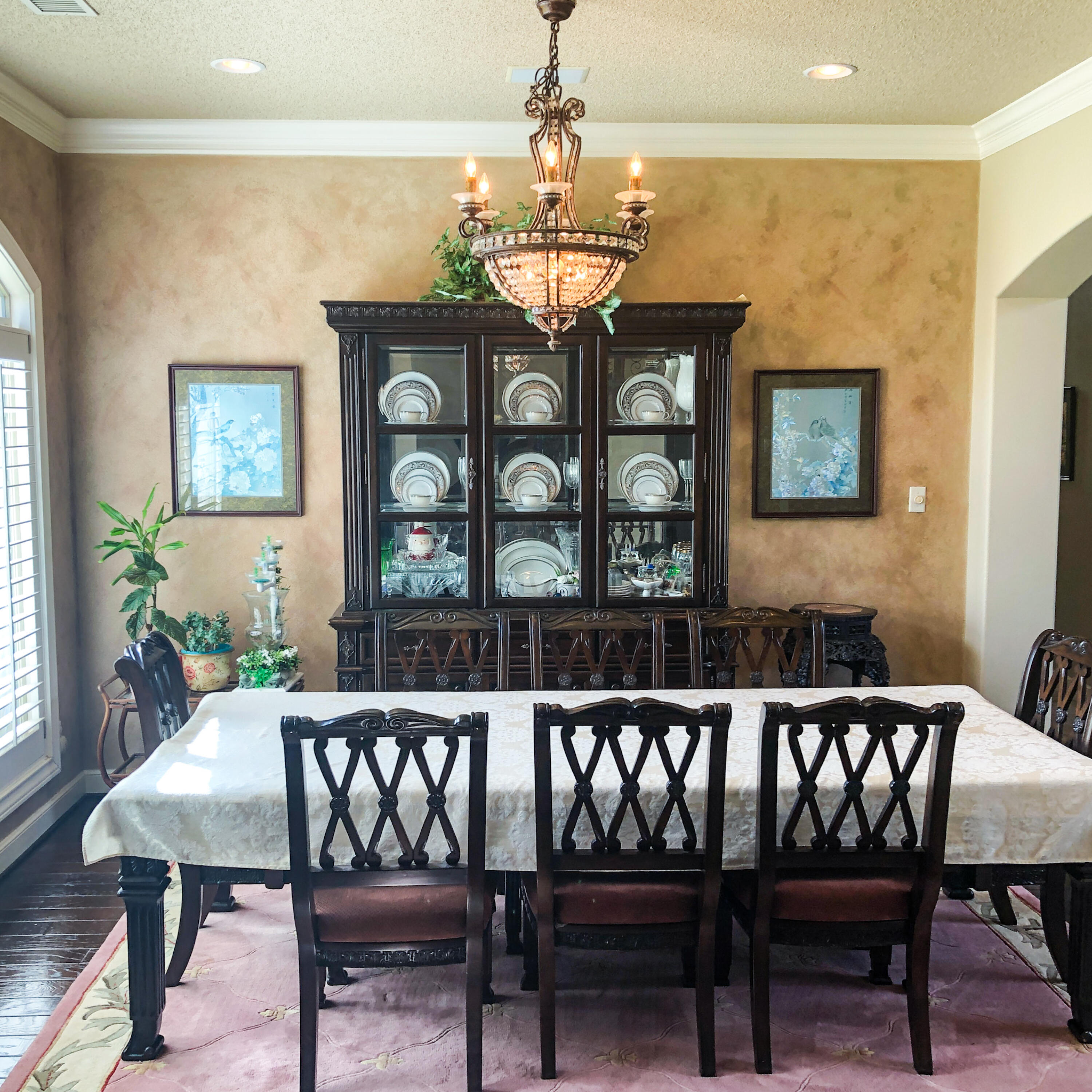 5502 156th Street Lubbock, TX 79424 - Photo 14 of 37 a view of a dining room with furniture wooden floor and chandelier