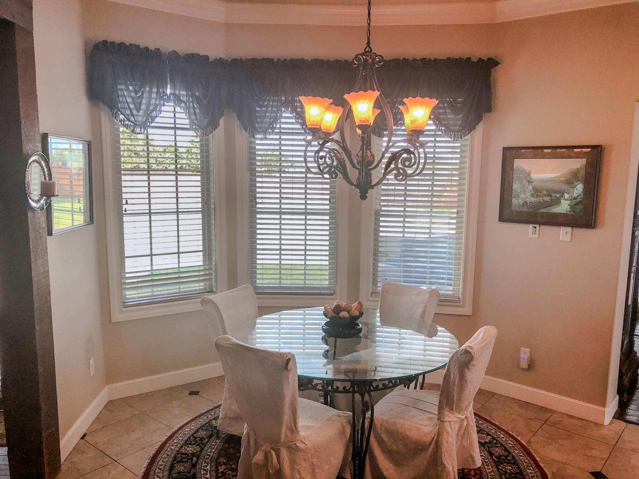 5502 156th Street Lubbock, TX 79424 - Photo 17 of 37 a view of a dining room with furniture and chandelier