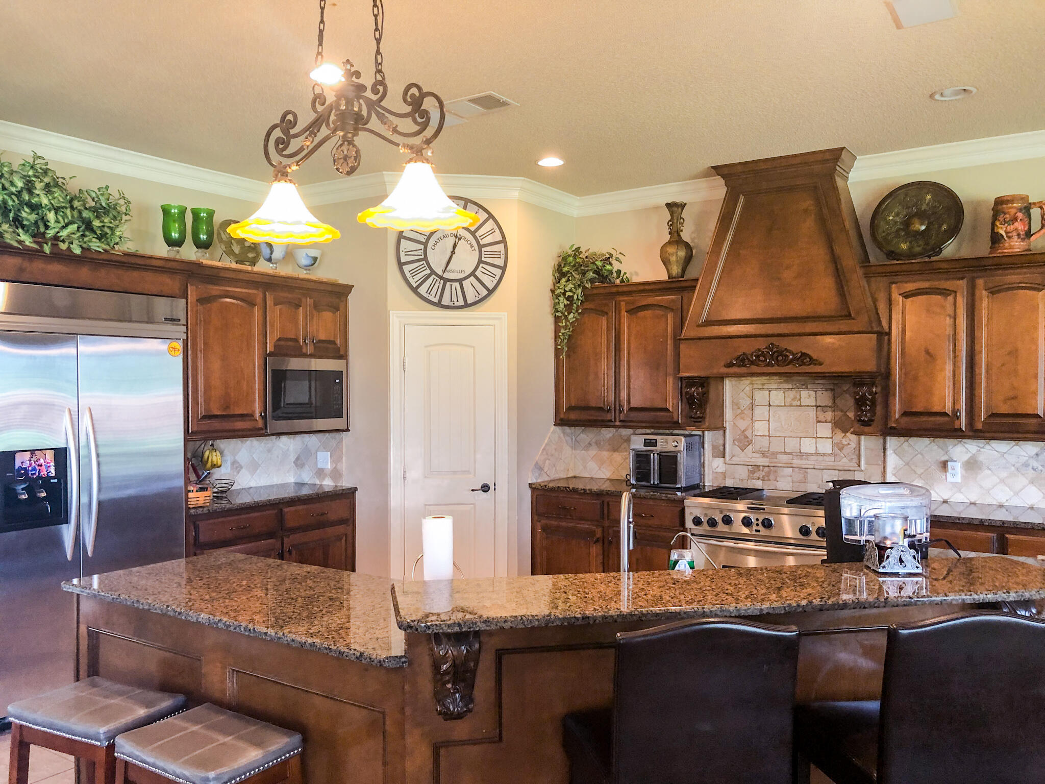 5502 156th Street Lubbock, TX 79424 - Photo 18 of 37 a kitchen with stainless steel appliances granite countertop a sink a stove and a refrigerator