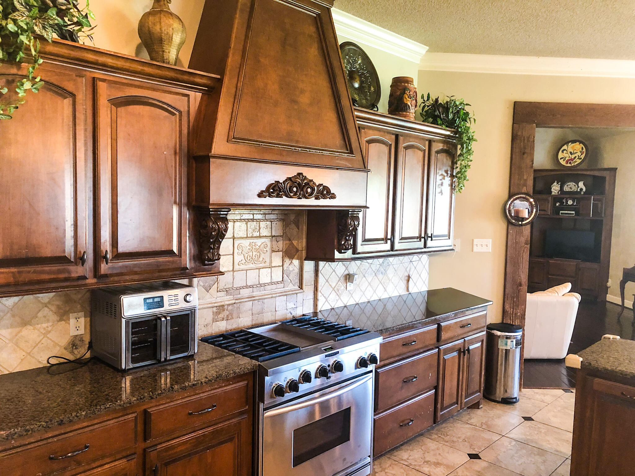 5502 156th Street Lubbock, TX 79424 - Photo 19 of 37 a kitchen with stainless steel appliances granite countertop a stove and a microwave