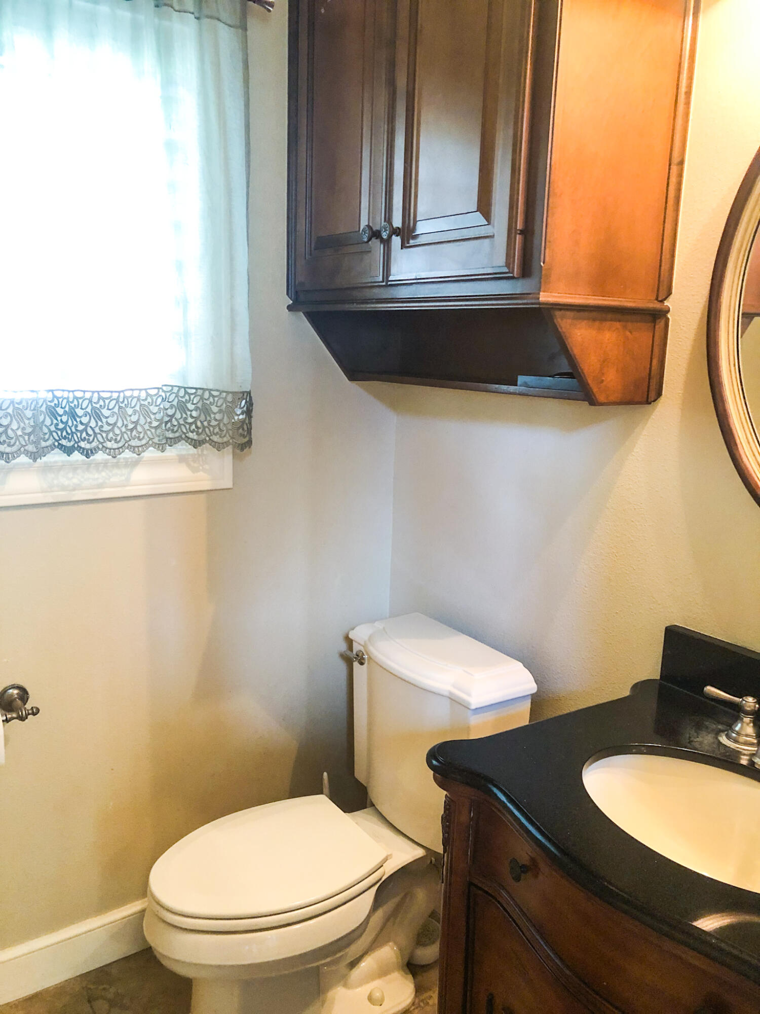 5502 156th Street Lubbock, TX 79424 - Photo 21 of 37 a bathroom with a toilet a sink and mirror