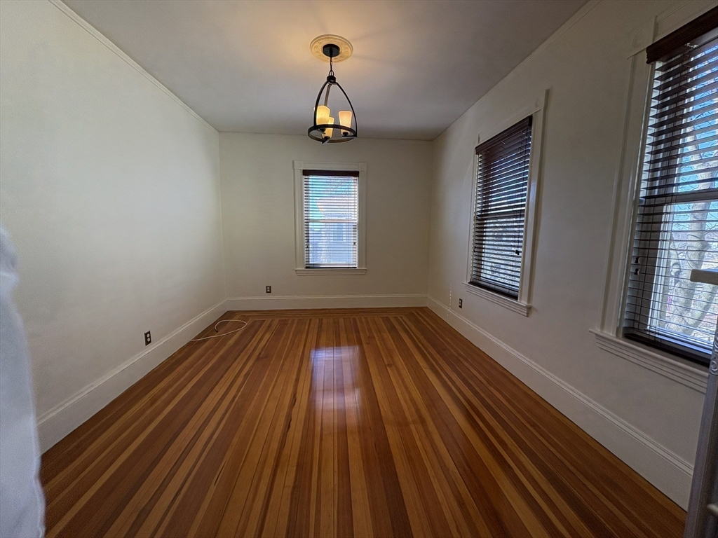 62 Ibbetson Street, Unit 3L Somerville, MA 02143 - Photo 7 of 20 a view of empty room with wooden floor and fan