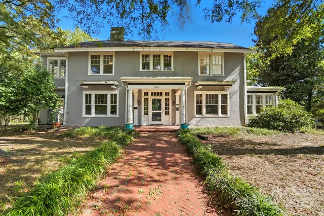 a front view of a house with a garden