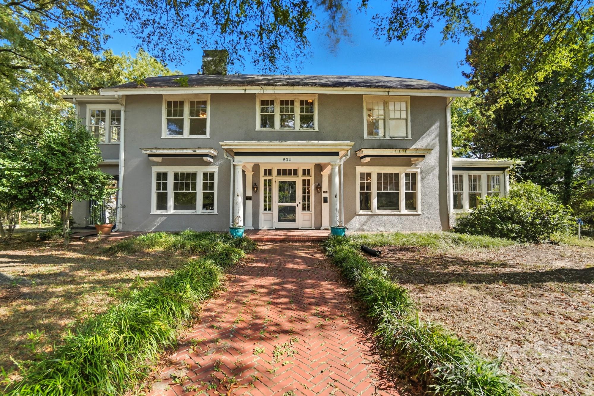a front view of a house with a garden