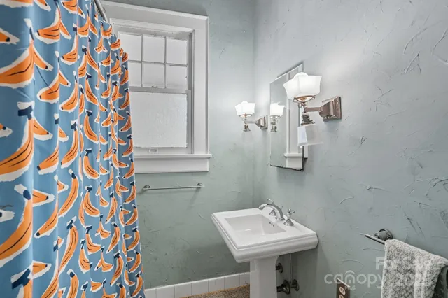 a bathroom with a sink a mirror and shower