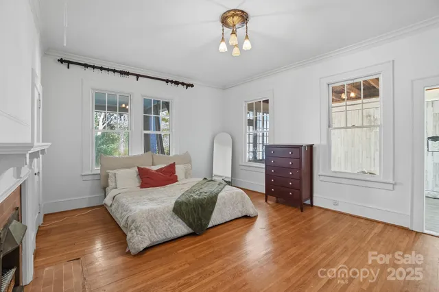 a bedroom with a bed dresser and a window