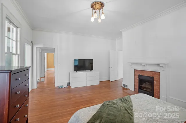 a bedroom with furniture and a fireplace