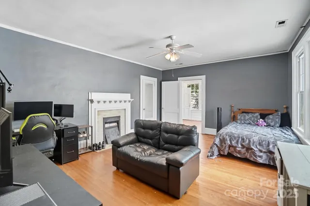a bedroom with a bed couch and a fireplace