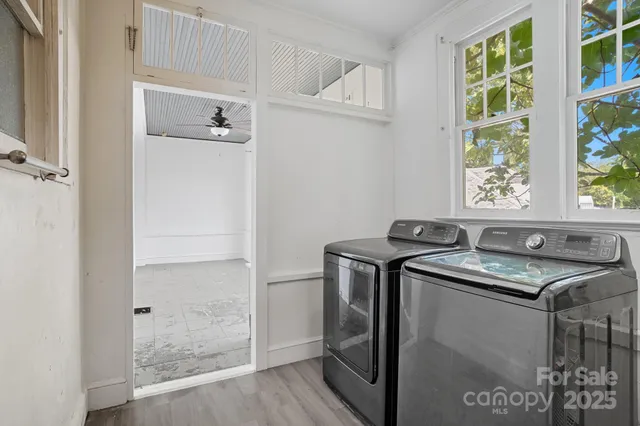a utility room with closet wooden floor and windows