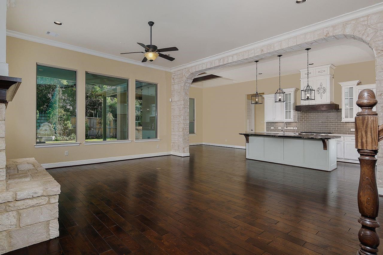 330 Mill Creek Road Pinehurst, TX 77362 - Photo 6 of 36 a view of a kitchen with a sink wooden floor and a window