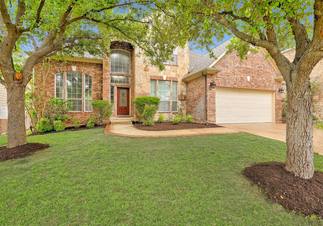 Welcome Home! This all brick exterior home is anchored by gorgeous mature oaks with a deep driveway (helpful if you have multiple drivers in the house!)