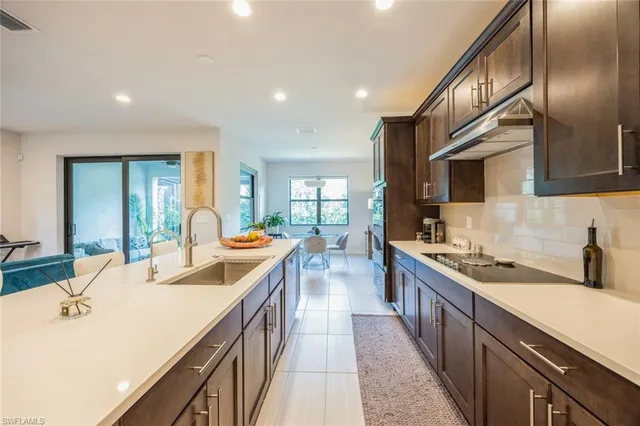 a kitchen with stainless steel appliances granite countertop sink stove and cabinets