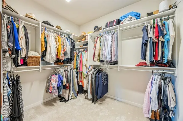 a view of walk in closet with clothes