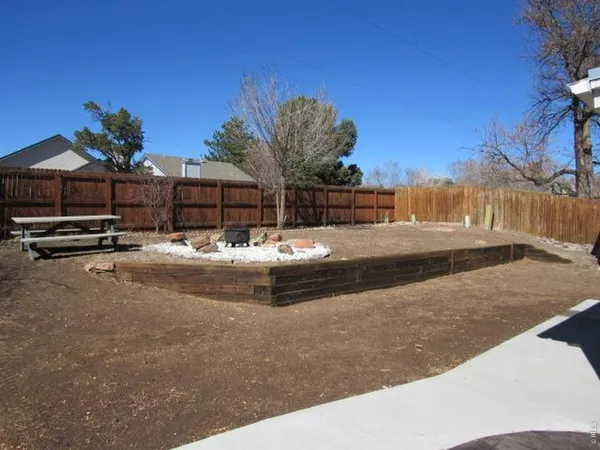 a view of swimming pool with outdoor seating and wooden fence