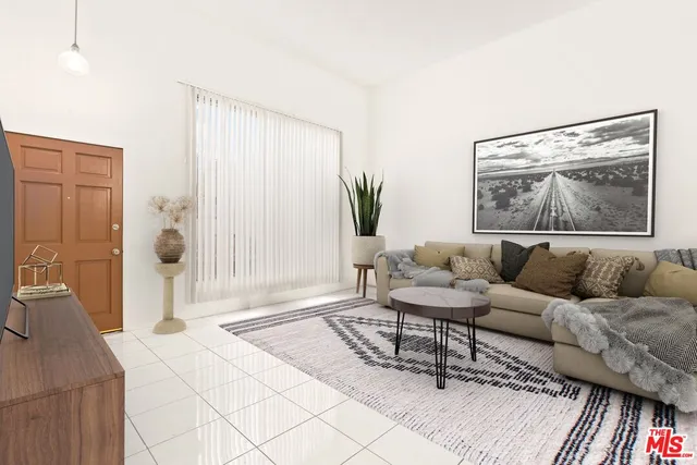 a living room with furniture and a painting on the wall