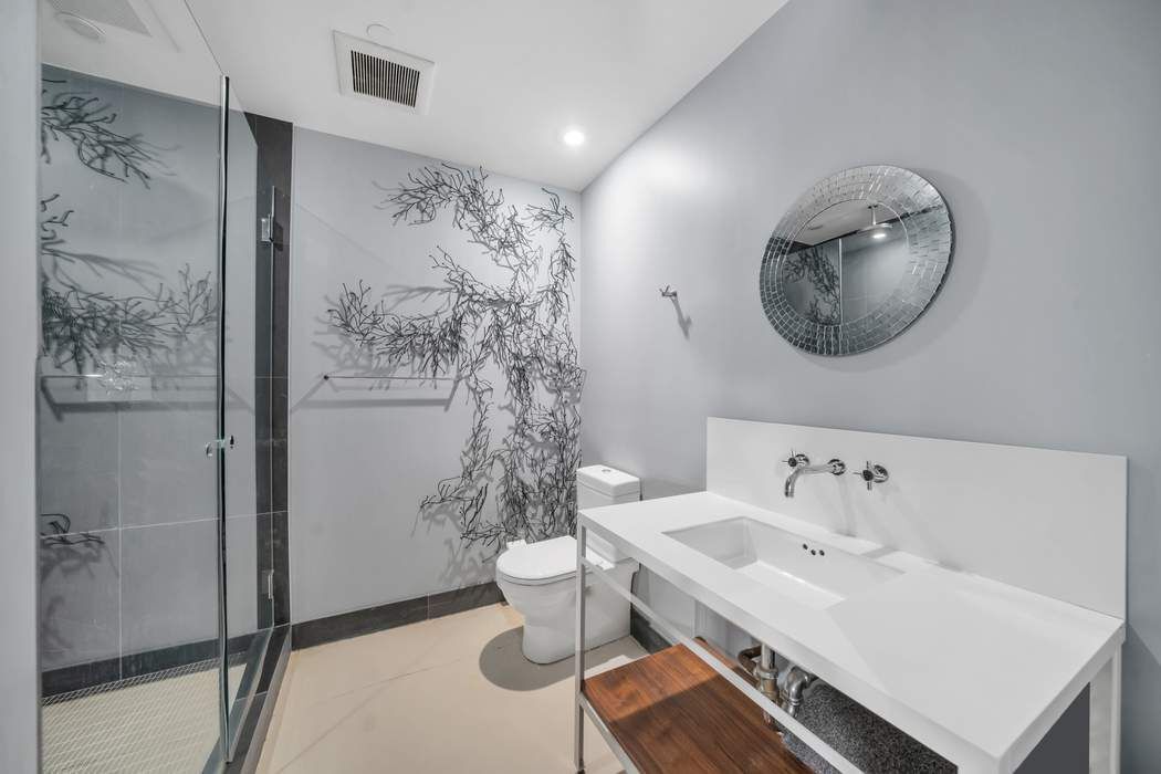 876 Broadway, Unit 3 Manhattan, NY 10003 - Photo 11 of 13 a bathroom with a sink toilet and mirror