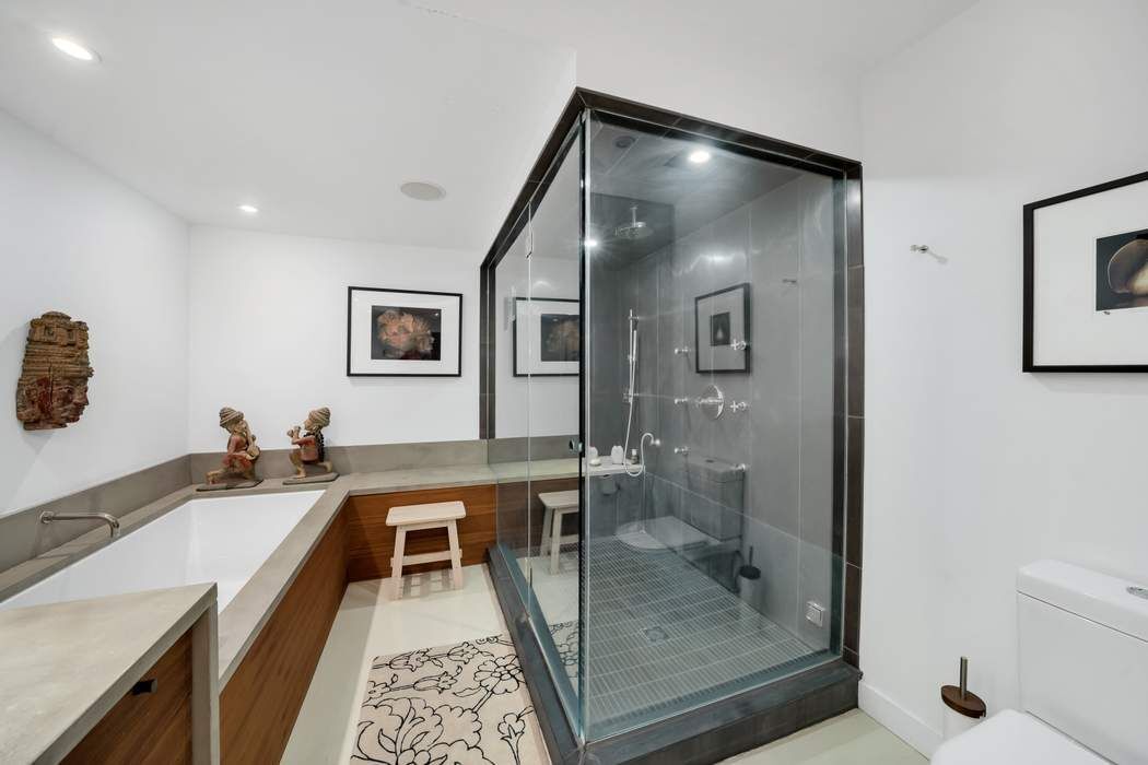 876 Broadway, Unit 3 Manhattan, NY 10003 - Photo 12 of 13 a en suite bathroom with a double vanity sink and a mirror