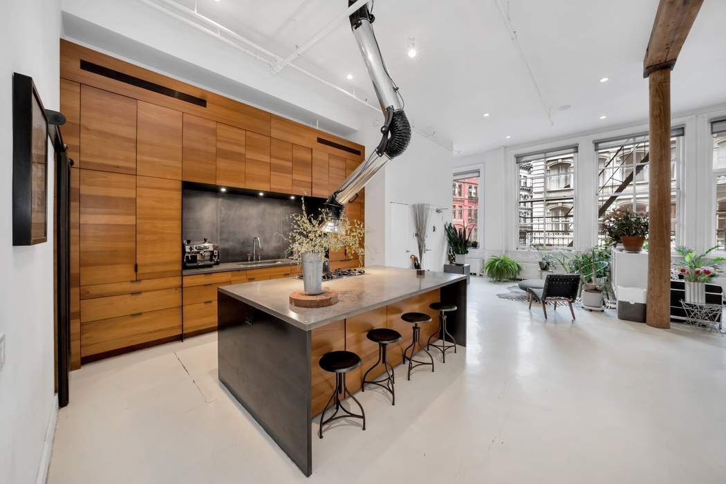 876 Broadway, Unit 3 Manhattan, NY 10003 - Photo 4 of 13 a living room with furniture a large window and wooden floor