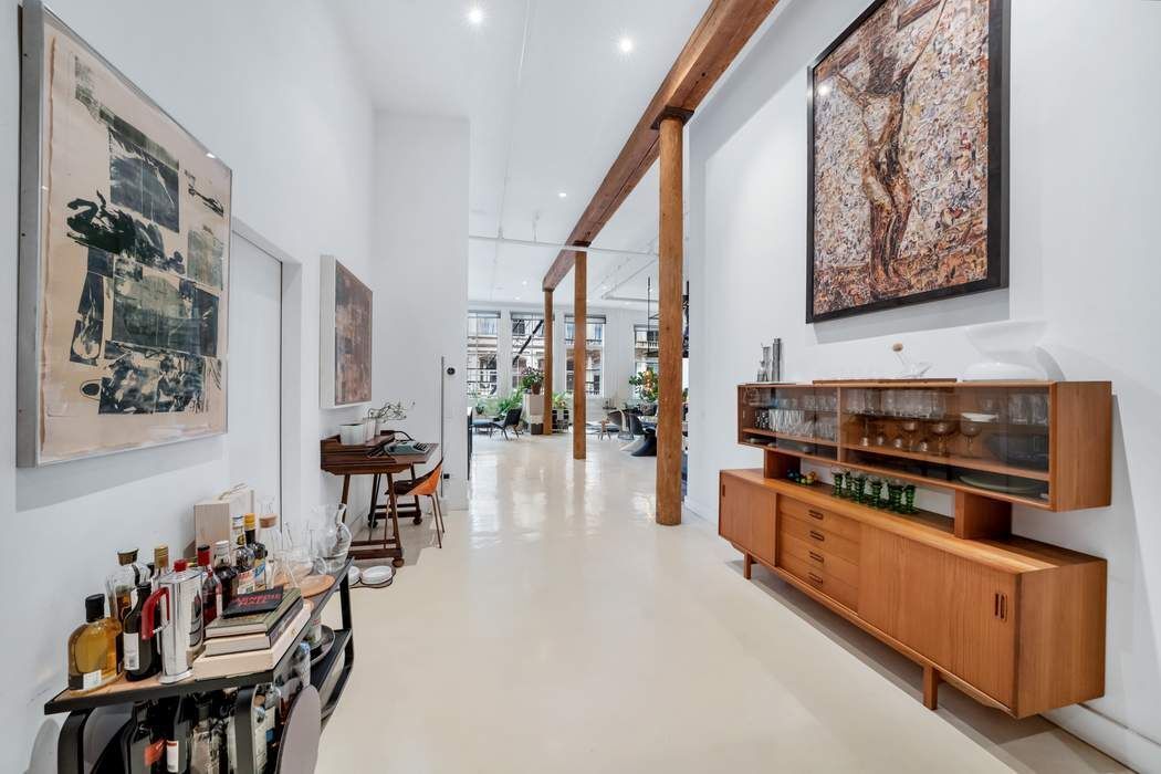 876 Broadway, Unit 3 Manhattan, NY 10003 - Photo 6 of 13 a kitchen with stainless steel appliances a stove a table and chairs
