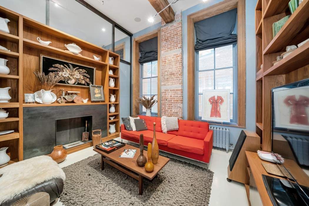 876 Broadway, Unit 3 Manhattan, NY 10003 - Photo 7 of 13 a living room with furniture fireplace and a large window