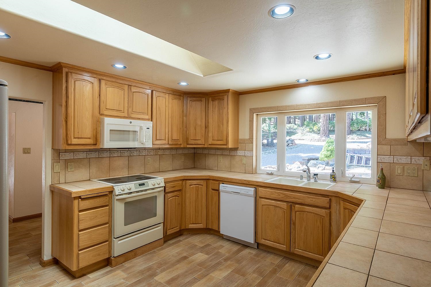 99 Catfish Lane Calpine, CA 96124 - Photo 12 of 21 a kitchen with a sink stove and cabinets