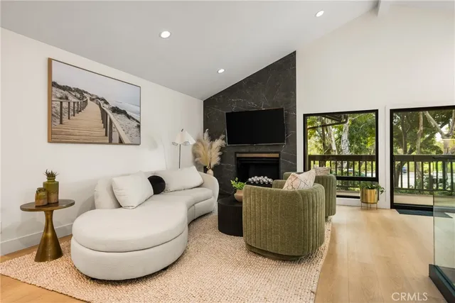 a living room with furniture large window and flat screen tv