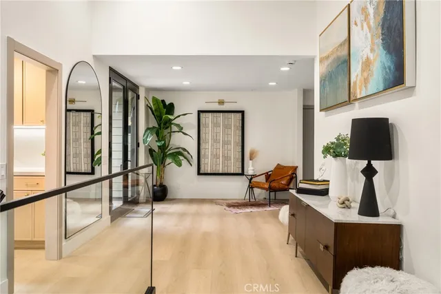a dining room with furniture a chandelier and wooden floor