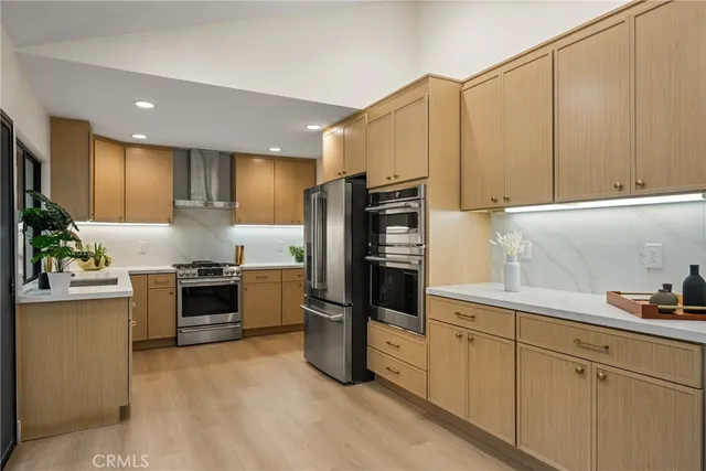 a large kitchen with a large window and stainless steel appliances
