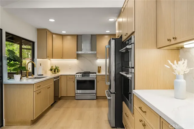 a kitchen with a sink stainless steel appliances and cabinets