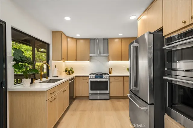 a kitchen with a sink cabinets and window