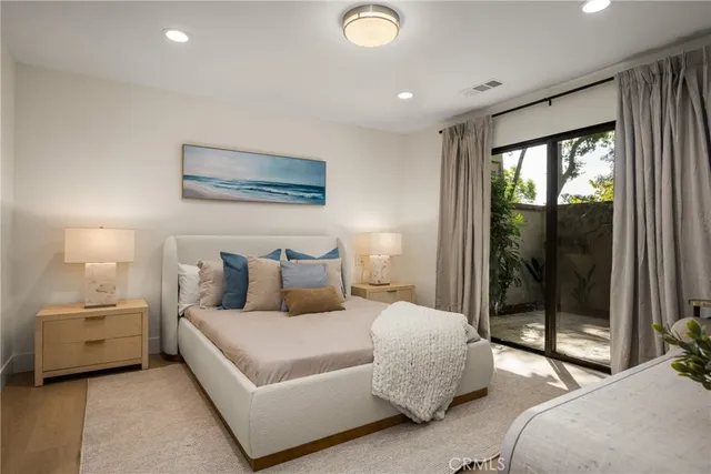 a bedroom with a bed and night stand