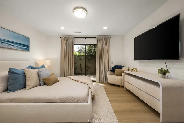 a bedroom with a bed and a flat screen tv