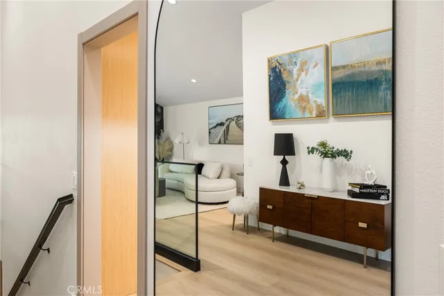 a living room with furniture a flat screen tv and a floor to ceiling window