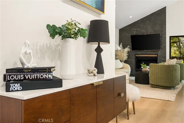 a living room with furniture a flat screen tv and a floor to ceiling window