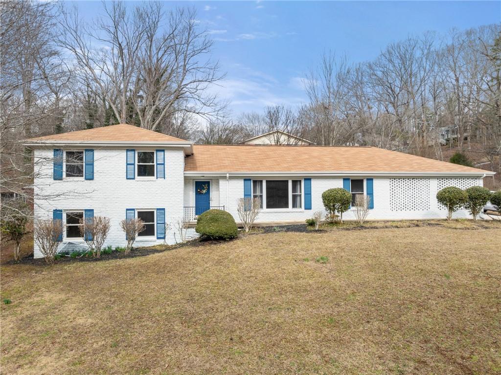 1002 Dixon Drive Gainesville, GA 30501 - Photo 1 of 37 a front view of a house with a yard and garage