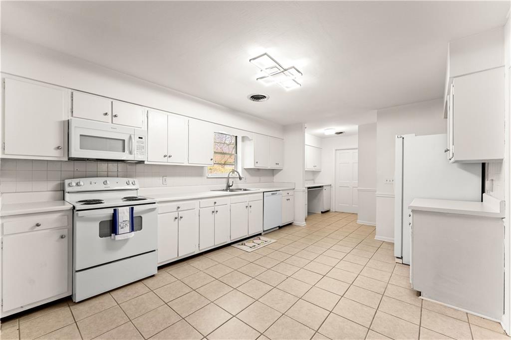 1002 Dixon Drive Gainesville, GA 30501 - Photo 12 of 37 a large white kitchen with cabinets