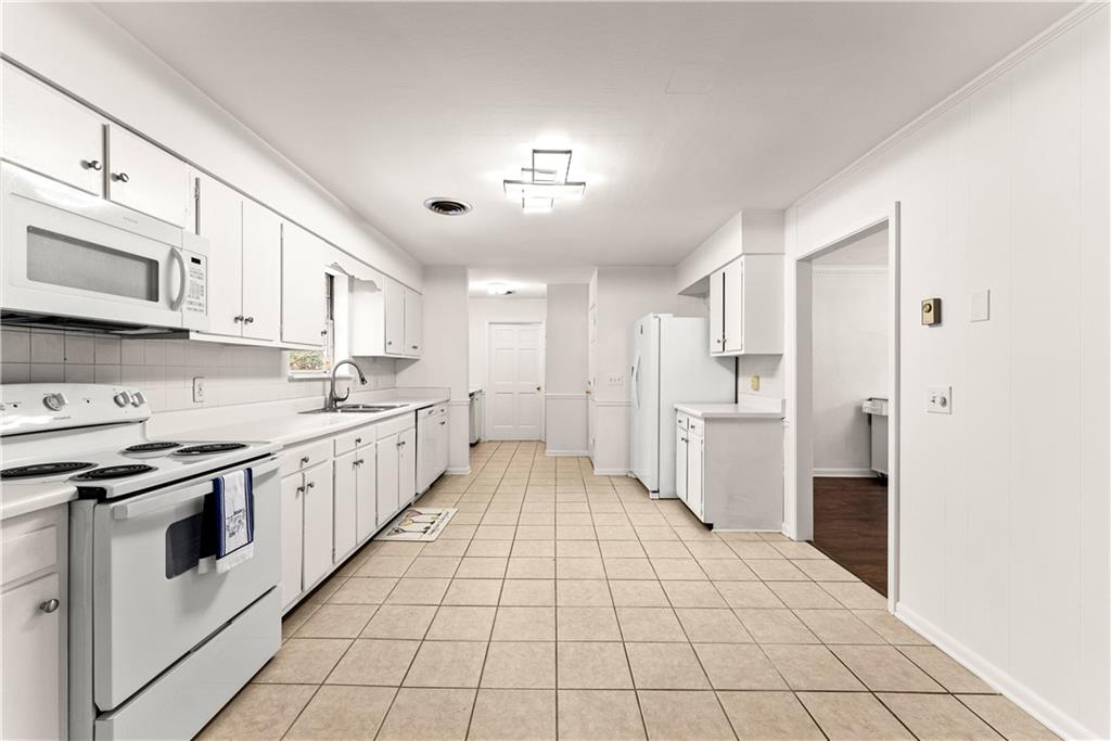 1002 Dixon Drive Gainesville, GA 30501 - Photo 13 of 37 a large white kitchen with cabinets