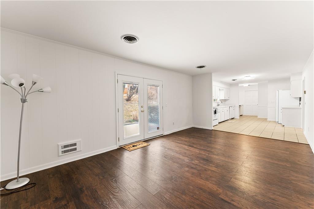 1002 Dixon Drive Gainesville, GA 30501 - Photo 15 of 37 an empty room with wooden floor and windows