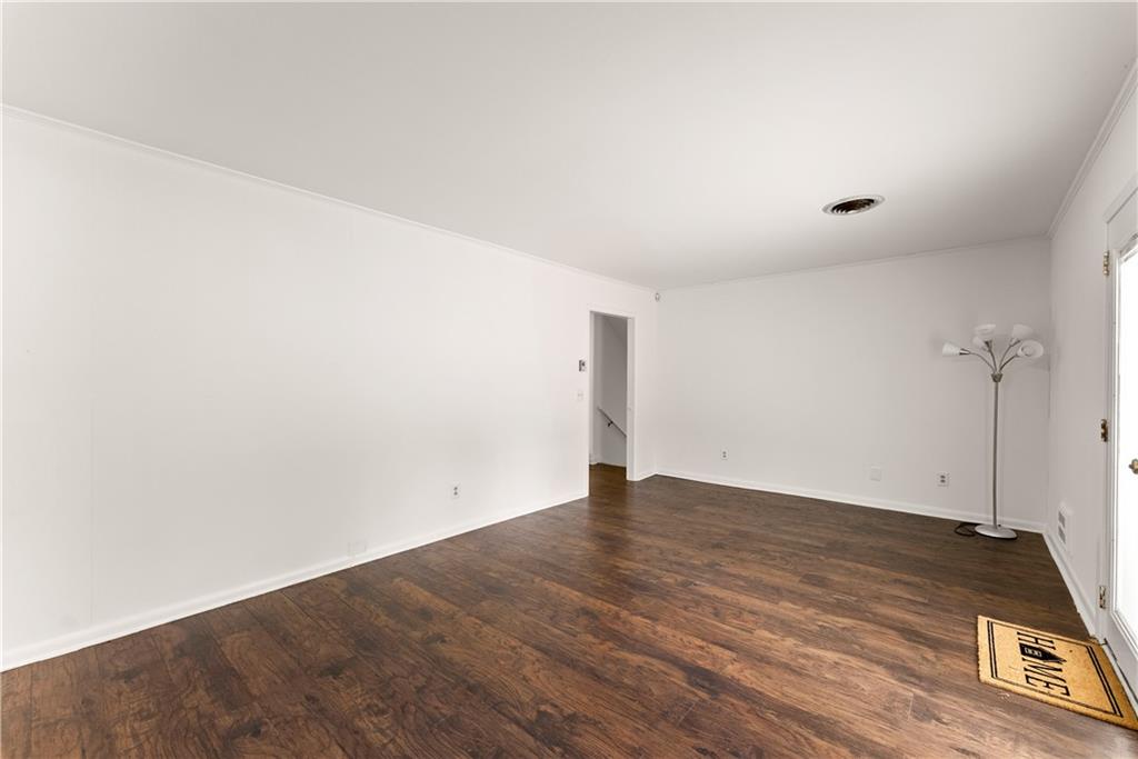 1002 Dixon Drive Gainesville, GA 30501 - Photo 16 of 37 an empty room with wooden floor and windows