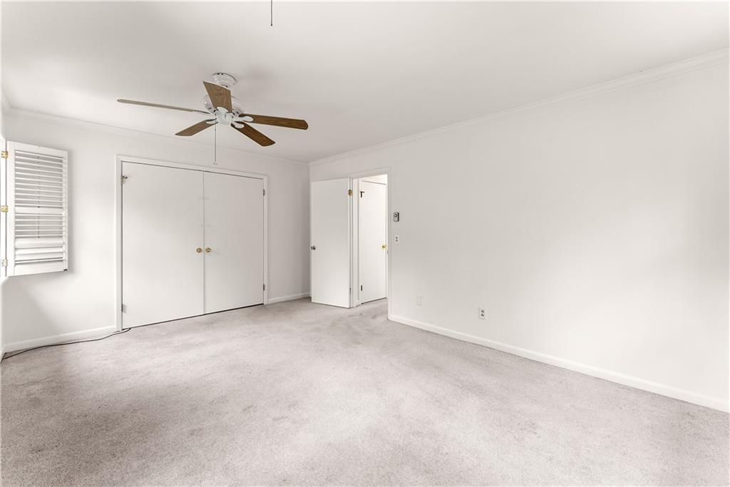 1002 Dixon Drive Gainesville, GA 30501 - Photo 22 of 37 an empty room with a ceiling fan and window