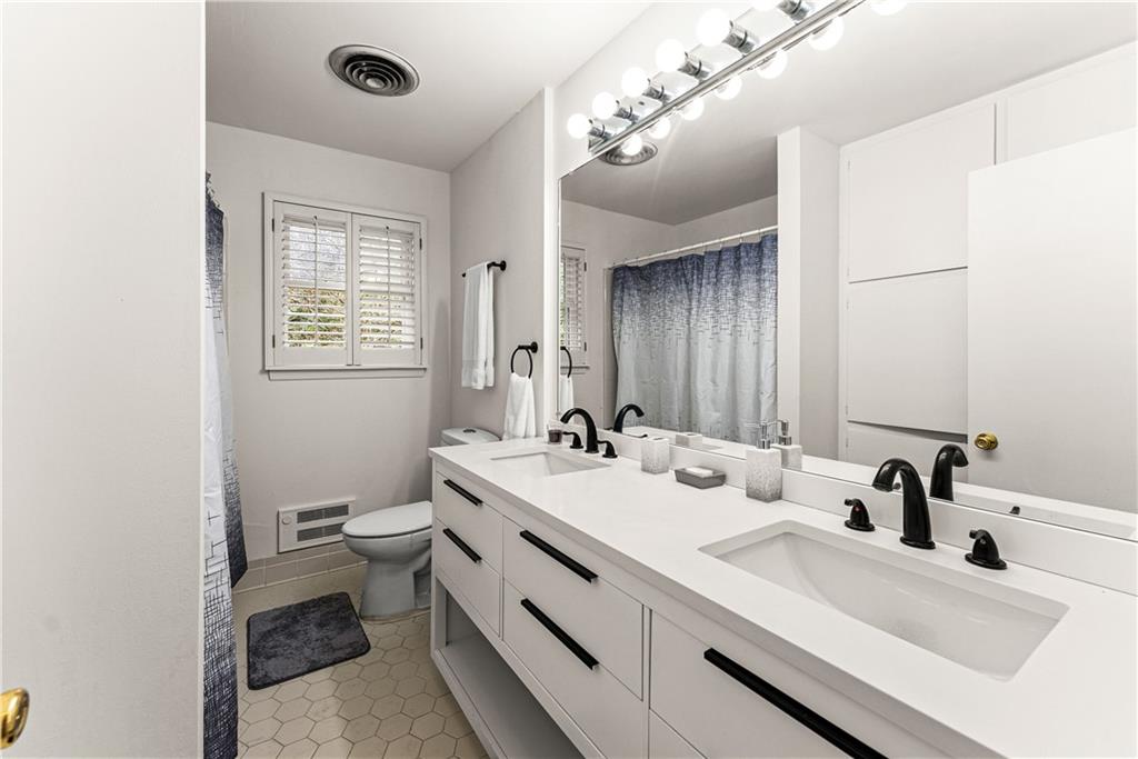 1002 Dixon Drive Gainesville, GA 30501 - Photo 23 of 37 a bathroom with a sink double vanity and a mirror