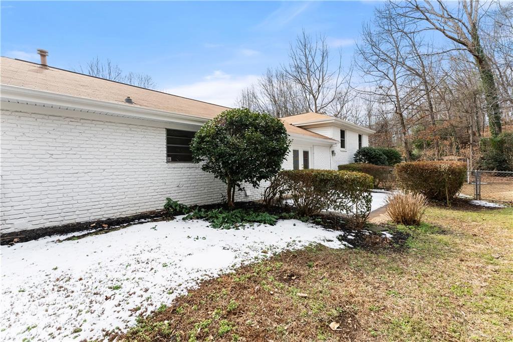 1002 Dixon Drive Gainesville, GA 30501 - Photo 27 of 37 a view of white house with a yard covered with snow in front of house