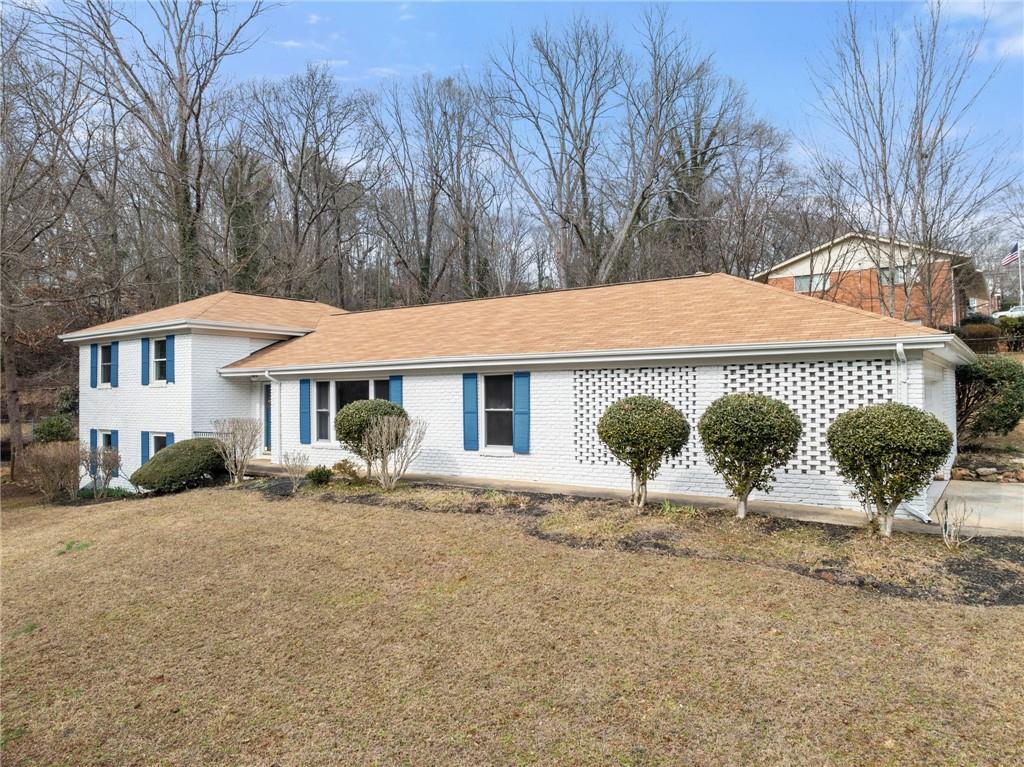 1002 Dixon Drive Gainesville, GA 30501 - Photo 5 of 37 a backyard of a house with yard and seating area