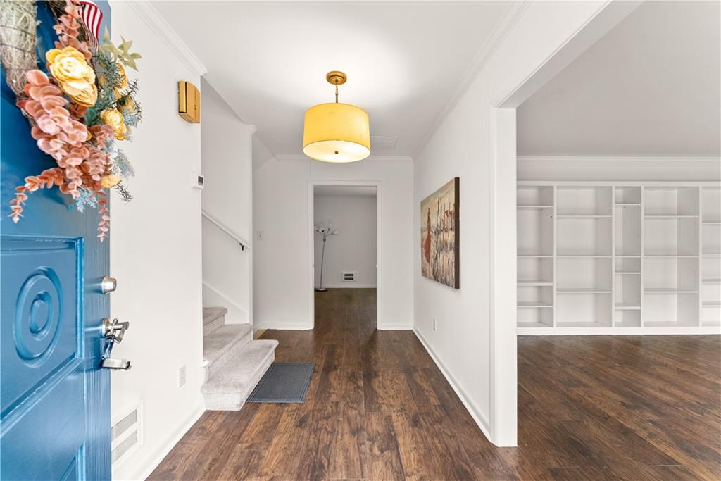 1002 Dixon Drive Gainesville, GA 30501 - Photo 7 of 37 a view of a hallway with wooden floor and staircase