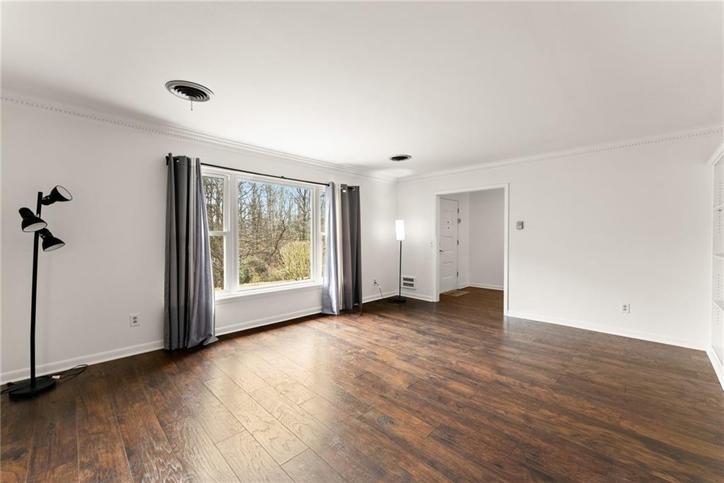 1002 Dixon Drive Gainesville, GA 30501 - Photo 9 of 37 an empty room with wooden floor and windows