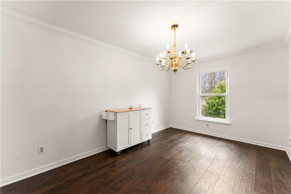 1002 Dixon Drive Gainesville, GA 30501 - Photo 10 of 37 an empty room with wooden floor and windows