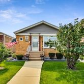 a front view of house with yard and green space